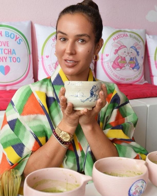 Selin Uncuoglu holding a bowl of matcha at the pink Matcha Bunny bar in Basel